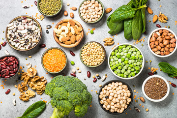 Wall Mural - Vegan protein source. Legumes, beans, lentils, nuts, broccoli, spinach and seeds. Top view on stone table. Healthy vegetarian food.