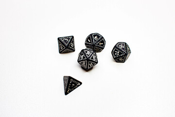 RPG dice in various shapes, runic on a white background, from the upper perspective