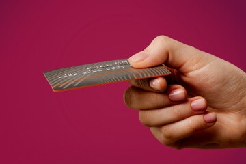 Poster - Young female hand and template Bank credit card with online service on background