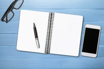 Canvas Print - Desk with pen, glasses, smartphone and notebook