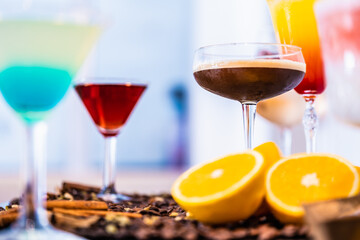 Sticker - A bunch of different gourmet cocktails on a bar table with coffee beans