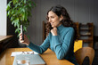 © DimaBerlin - Happy girl with smartphone phone looking at screen video calling distance friend online in mobile chat. Joyful woman talk using videochat application on cellphone in office on break. Web communication