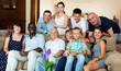 © JackF - Portrait of big happy family gathering in parental home, posing together on couch