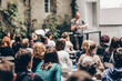 © kasto - Man giving presentation in lecture hall at university.