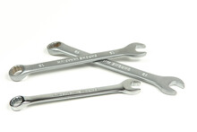 A Group Of New Metal Wrenches For Tightening Bolts And Nuts On A White Background