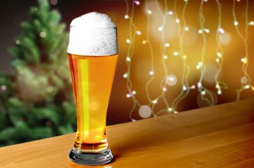 Canvas Print - Beer in mug on wooden table with Christmas background