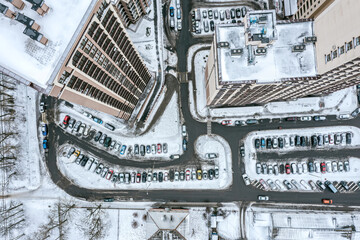 Wall Mural - new modern complex of high-rise apartment buildings. courtyard with parked cars. aerial top view in wintertime.