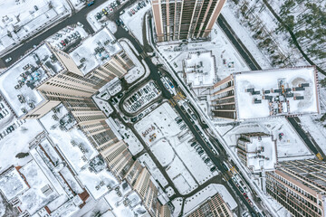 Wall Mural - courtyard with parked cars surrounded by high-rise residential buildings. winter cityscape. aerial top view.