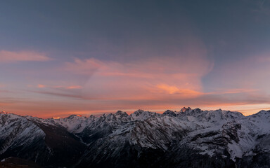 Wall Mural - Beautiful colorful sunset sky. Panoramic view of mountain range of the Caucasus Mountains. View from the top of the mountain. Elbrus region