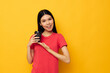 © Tatiana - woman in a red t-shirt glass with a drink yellow background