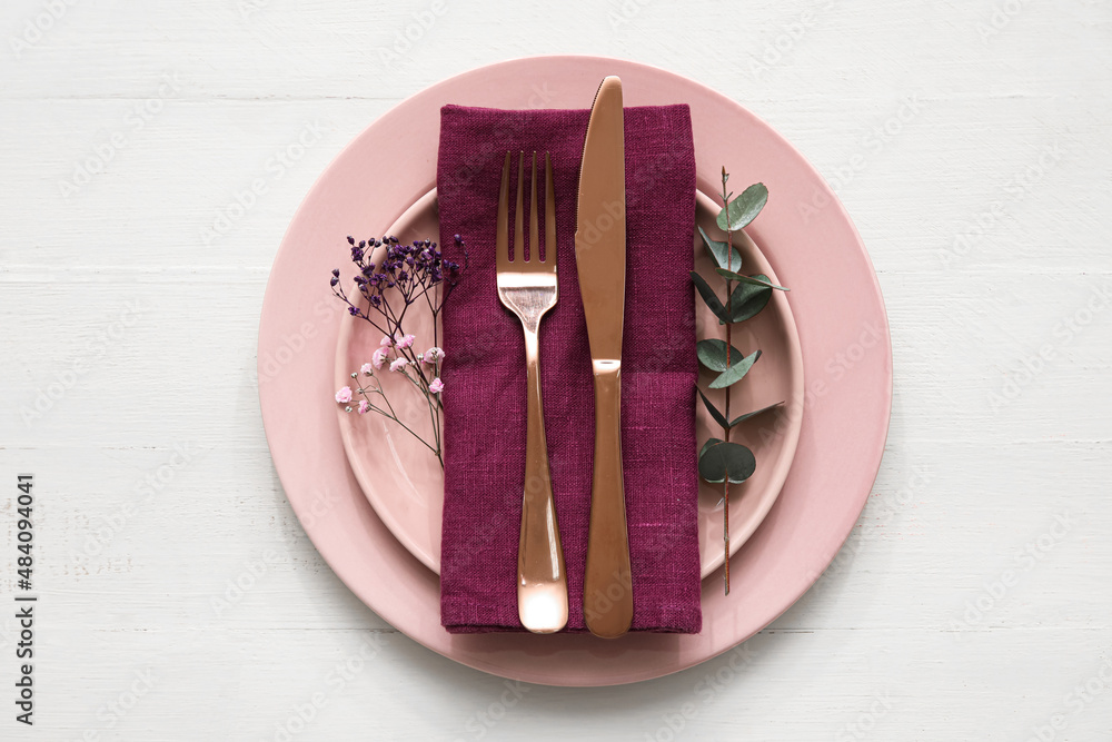 Stylish table setting and flowers on light wooden background