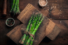 Vintage Styling Of A Fresh Asparagus Bunch On Top Of An Old Wooden Table