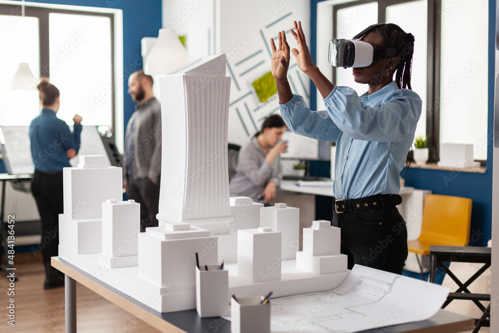 Architect working with virtual reality goggles to look at white foam ...