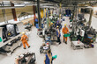 © Maskot - Female and male workers wearing uniform working in factory warehouse
