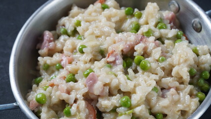 Classic italian risotto with peas, cheese parmesan, prosciutto. Risi e Bisi (Venetian-style rice and peas)