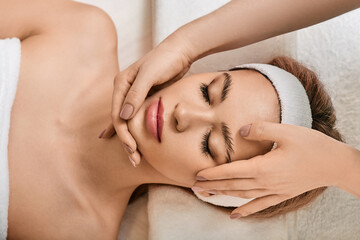 Facial massage. Beautiful woman during face massage for lifting face skin and facial elastic in wellness spa