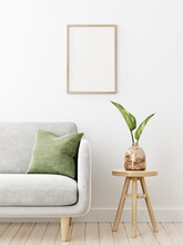 Vertical Brown Frame Mockup In Interior With Gray Sofa, Green Cushion And Plant Leaves In Vase On Empty White Wall Background. Illustration, 3d Rendering