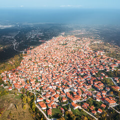 Wall Mural - Aerial drone view above the traditional red roofs of a resort town or village. The concept of real estate and travel in Europe