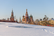 Winter Shot Of The Moscow Kremlin And St. Basil's Cathedral With A Snowy Meadow In The Foreground. Russian Winter. Famous Place In Winter