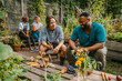 © Maskot - Happy male and female farmers talking while sitting in community garden