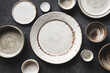 Modern Trendy Craft Ceramic Plates And Bowls On Concrete Table Background. Top View Copy Space. Kitchenware