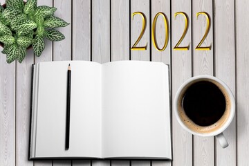 Canvas Print - New year goals 2022 on desk. A table with coffee cup, notebook and plant. Resolutions, plan, goals, business concept.