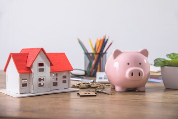 piggy bank with house and coins