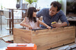 © Odua Images - fahter and daughter Putting Together Self Assembly Furniture
