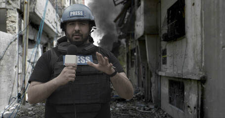 POV Camera view, War journalist correspondent wearing bulletproof vest and helmet reporting live from destroyed town