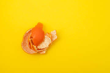 Poster - fresh orange mandarin peel on yellow background