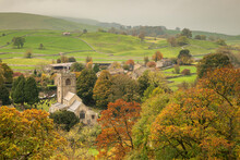 Autumn Colours Surround St. Wilfrid's Church In The Yorkshire Dales Village Of Burnsall, Wharfedale, North Yorkshire, England