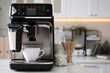 © New Africa - Modern coffee machine with cup in office kitchen, space for text
