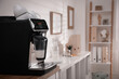 © New Africa - Modern coffee machine on table in office. Space for text