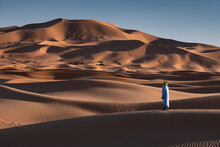 A Berber Man In Traditional Dress In The Sand Dunes Of Erg Chebbi, Sahara Desert