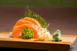 © EZ PHOTOS - Sashimi japanese food, pieces of tuna, salmon in a wooden background. Fish slices. Front view with Copy Space.