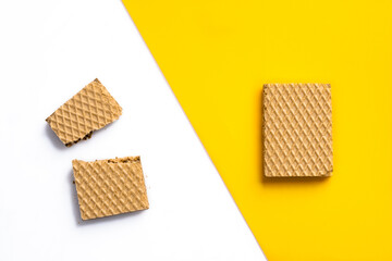 Chocolate wafers on white yellow background	