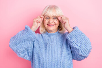 Wall Mural - Photo of cheerful senior woman hands touch eyeglasses ophthalmology isolated over pink color background