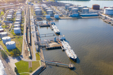 Wall Mural - Aerial view large port with railway infrastructure for the delivery of bulk cargo by sea, loading oil using a pump station in ship tanker for transportation and delivery.