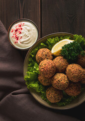 Wall Mural - Chickpea falafel balls, on a wooden table, close-up, vegetarian food,