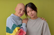 Diverse women posing at camera supporting each other, asian and another caucasian bald models, looking at camera smiling. Portrait of ladies in casual outfit having close relationships. alopecia