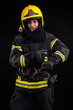 © blanke1973 - Firefighter in full firefighting gear on a black background
