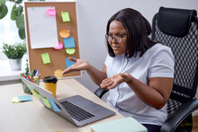Angry Frustrated Black Woman Spreading Arms Misunderstanding, Working Online On Laptop In Modern Bright Office Room, Looking At Screen, Upset By Something, Manager Working Alone. What The Hell