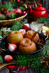 Wall Mural - Vertical composition. Baked apples with cinnamon sticks on a dark wooden background