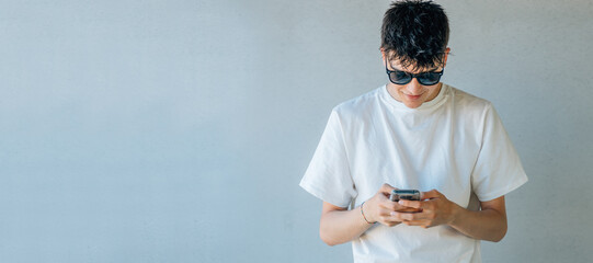 young teenager with sunglasses and mobile phone with space