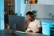 © DimaBerlin - Symptoms of overworking. Young tired overworked african man freelancer working late from home, sitting in front of monitor, massaging nose bridge, feeling eye strain and fatigue during computer work