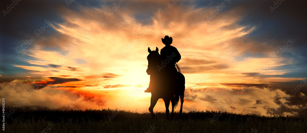 Cowboy on a horse at sunset