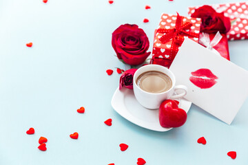 Wall Mural - Valentine day composition with coffee cup, rose flower and gift box on table. Top view, flat lay. Holiday concept.