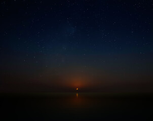 Wall Mural - crescent moon setting over calm waters