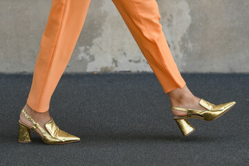 Wall Mural - woman wearing persian orange pants and golden shoes