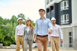 © zinkevych - Group of four people walking across a new building site